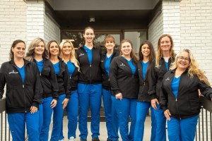 Group staff photo outside of building lined up